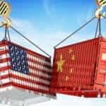Two shipping containers, with the American and Chinese flags, crashing into each other.