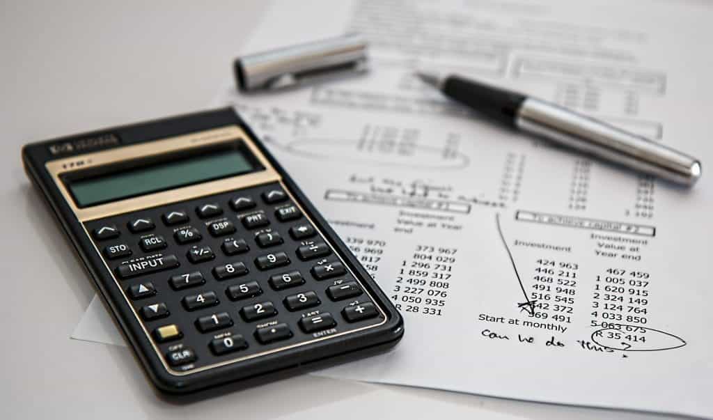 Financial papers with a pen and a calculator.