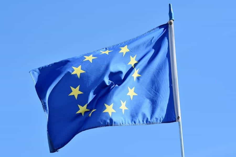 The flag of the European Union flying from a flagpole.