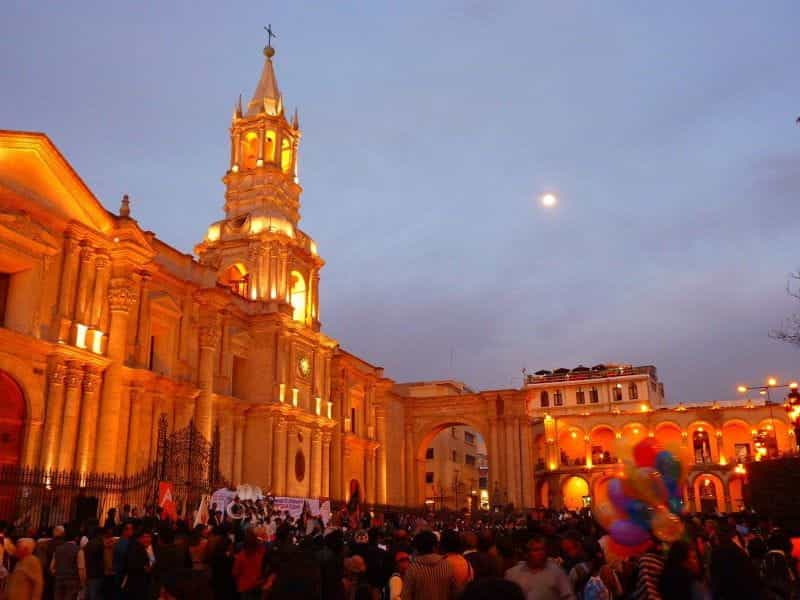 A festive crowd assembles outside of a historic building in Arequipa, Peru.