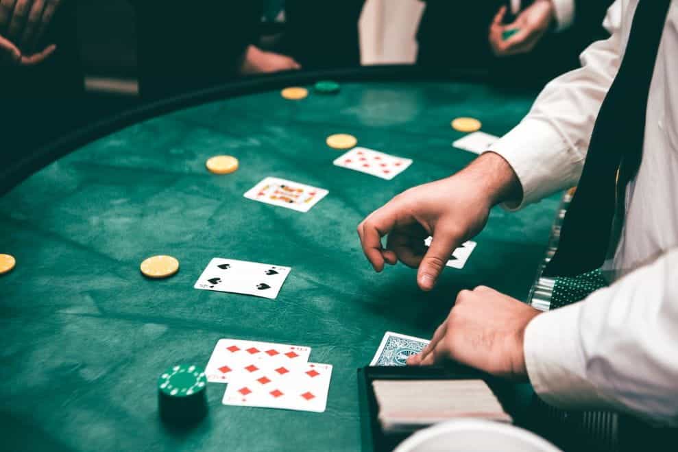 A croupier dealing cards and chips in a casino.