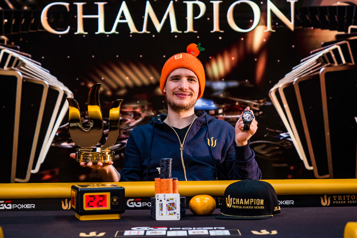 Roman Hrabec poses for the cameras following his Triton Poker Main Event win.